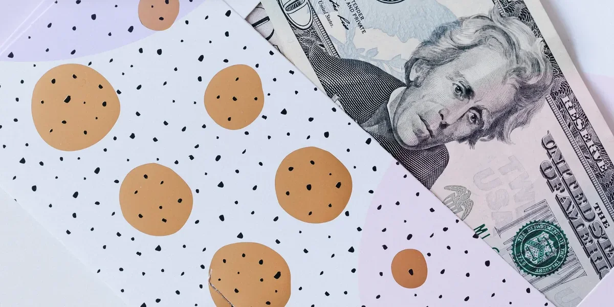 Cash gift setup with a patterned envelope and US money for a teen money gift reveal.